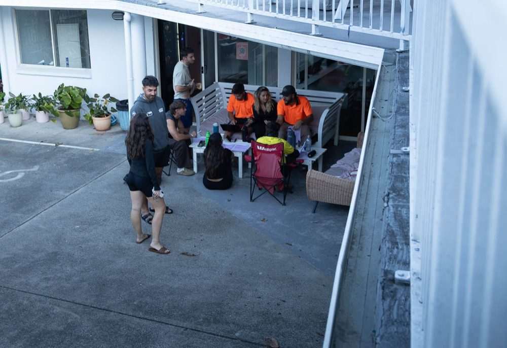 Travellers hanging out together outside at CALI Backpackers
