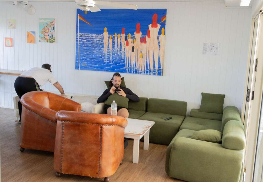 Lounge with colourful sofas and coastal artwork