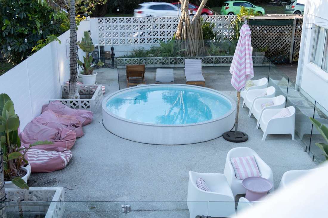 The heated plunge pool with loungers and umbrella